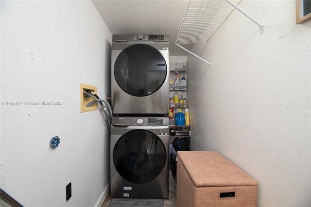 laundry area featuring laundry area and stacked washer and clothes dryer