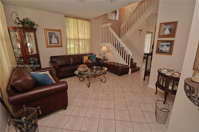 living room featuring visible vents, stairs, and light tile patterned floors
