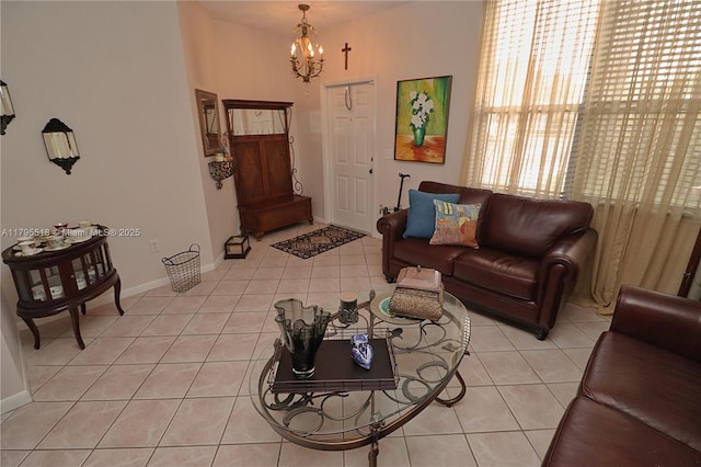 living area featuring light tile patterned flooring, baseboards, and a chandelier