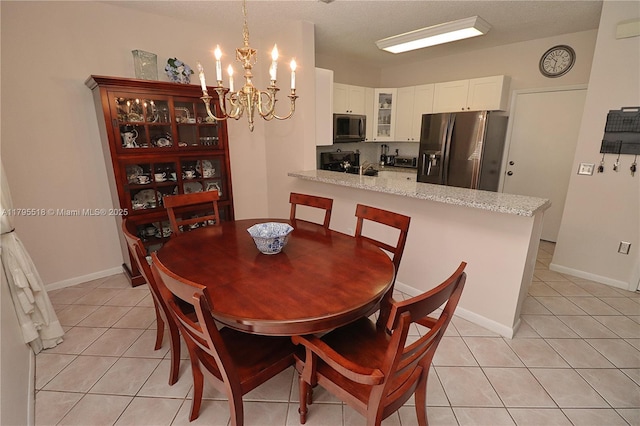 dining area with an inviting chandelier and light tile patterned floors