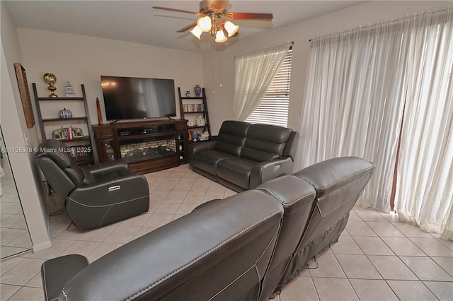 living room featuring ceiling fan and light tile patterned floors