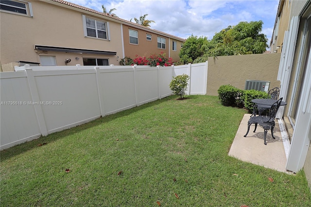 view of yard featuring a fenced backyard and central air condition unit
