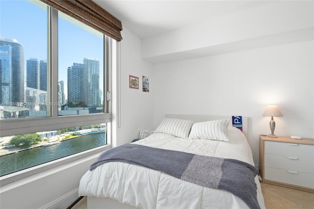 bedroom with a view of city and a water view