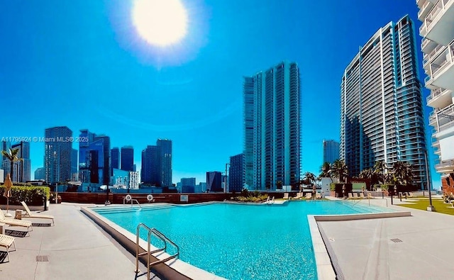 pool with a city view and a patio area