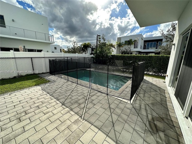 view of pool with a fenced in pool, a patio area, and fence
