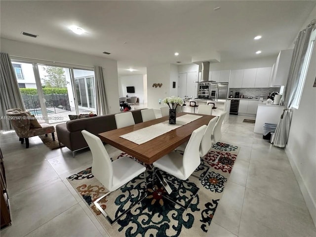 dining room featuring visible vents, light tile patterned flooring, baseboards, beverage cooler, and recessed lighting
