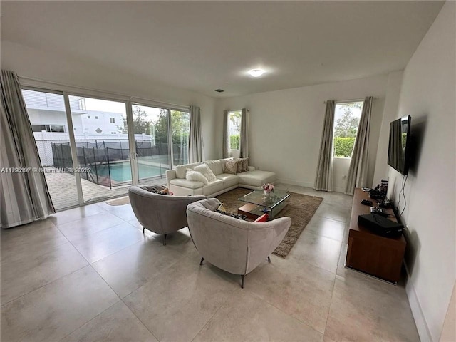 living room with baseboards and light tile patterned floors