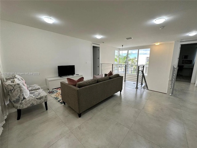 living room featuring light tile patterned floors and visible vents