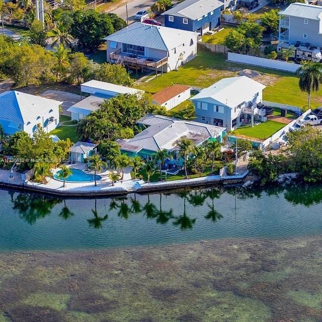 birds eye view of property with a water view and a residential view