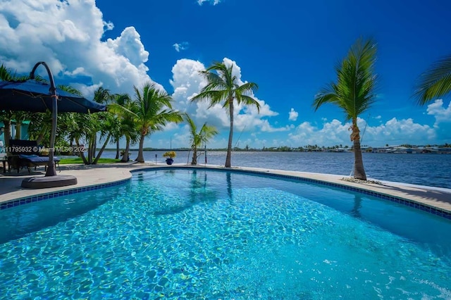 outdoor pool with a water view