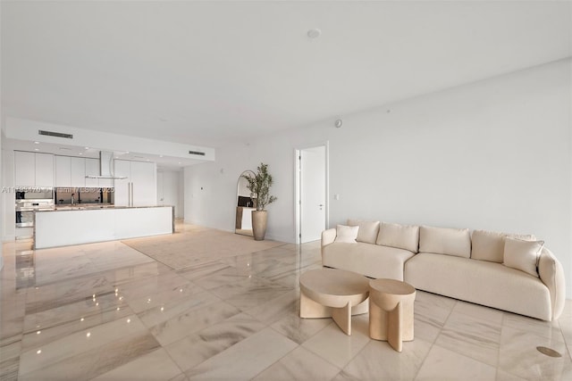 living area featuring visible vents and marble finish floor