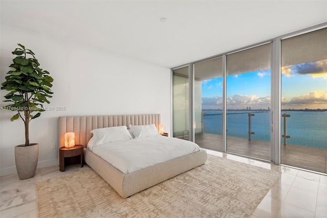 tiled bedroom featuring a water view, floor to ceiling windows, baseboards, and access to exterior