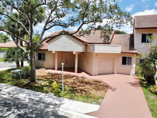 view of front of house featuring a garage, stucco siding, concrete driveway, and a tile roof