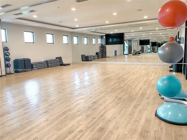 exercise room with recessed lighting, wood finished floors, and visible vents