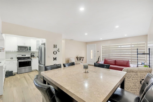 7295 W 14th Ct, Hialeah, FL 33014 - dining area featuring light wood-style flooring and recessed lighting