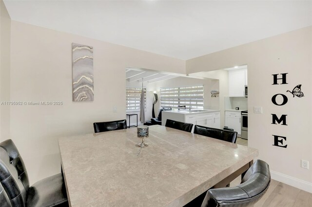 7295 W 14th Ct, Hialeah, FL 33014 - dining space with baseboards and light wood-type flooring