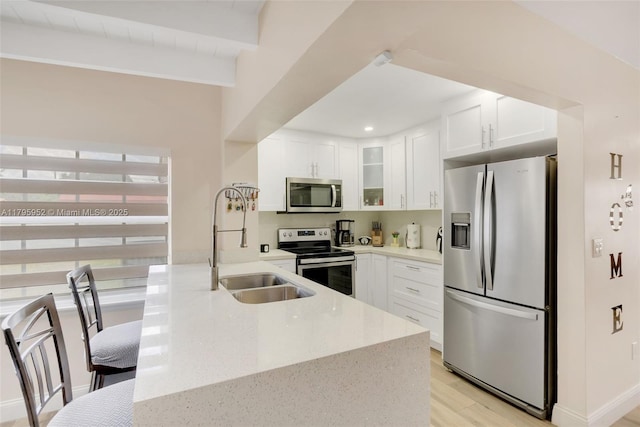 7295 W 14th Ct, Hialeah, FL 33014 - kitchen with appliances with stainless steel finishes, a sink, glass insert cabinets, light stone countertops, and light wood-style floors