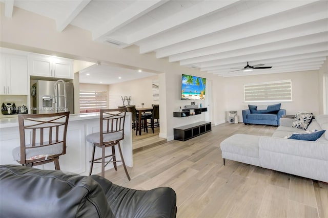 7295 W 14th Ct, Hialeah, FL 33014 - living area featuring light wood finished floors, beamed ceiling, ceiling fan, and recessed lighting