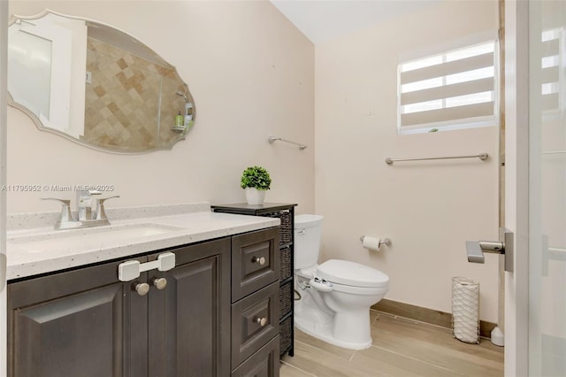 7295 W 14th Ct, Hialeah, FL 33014 - bathroom with toilet, vanity, wood finished floors, and baseboards