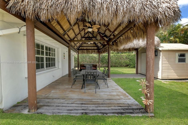 7295 W 14th Ct, Hialeah, FL 33014 - wooden terrace with a gazebo, outdoor dining area, a lawn, an outbuilding, and a storage unit