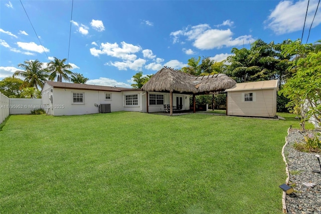 7295 W 14th Ct, Hialeah, FL 33014 - rear view of house with cooling unit, an outbuilding, stucco siding, and a storage unit
