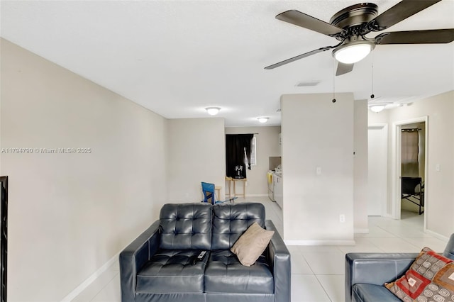 living room with visible vents, a ceiling fan, baseboards, and light tile patterned floors