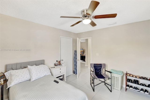 bedroom featuring light tile patterned flooring and a ceiling fan