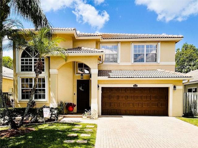 16541 Turquoise Trl, Weston, FL 33331 - view of front facade with decorative driveway, stucco siding, a tiled roof, and an attached garage