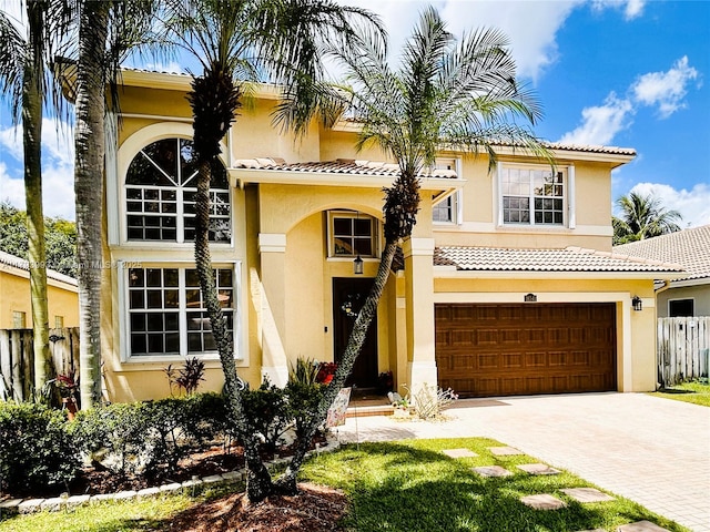 16541 Turquoise Trl, Weston, FL 33331 - mediterranean / spanish-style home with stucco siding, decorative driveway, a tiled roof, and a garage