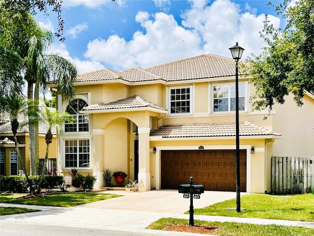 16541 Turquoise Trl, Weston, FL 33331 - mediterranean / spanish-style home featuring a tile roof, an attached garage, stucco siding, and concrete driveway
