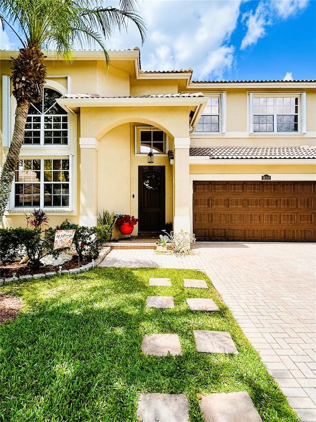 16541 Turquoise Trl, Weston, FL 33331 - view of front of home with stucco siding, an attached garage, and driveway