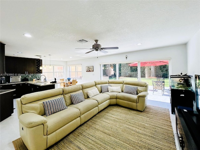 16541 Turquoise Trl, Weston, FL 33331 - living room featuring recessed lighting, healthy amount of natural light, ceiling fan, and a textured ceiling