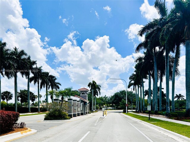 16541 Turquoise Trl, Weston, FL 33331 - view of asphalt road featuring street lights, curbs, and traffic signs