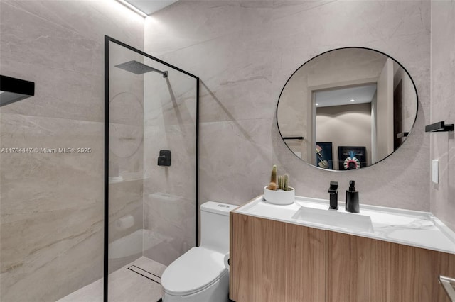 bathroom with toilet, tile walls, tiled shower, and vanity