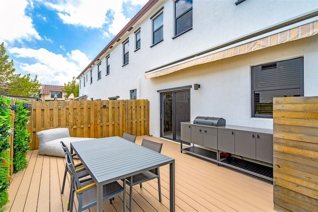deck featuring fence and outdoor dining space