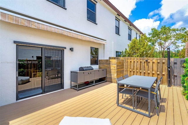 deck with outdoor dining area