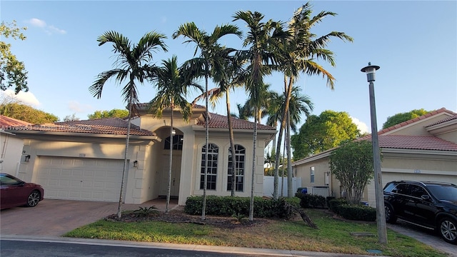 7310 NW 17th Ct, Pembroke Pines, FL 33024 - mediterranean / spanish home with a garage, a tile roof, driveway, stucco siding, and fence