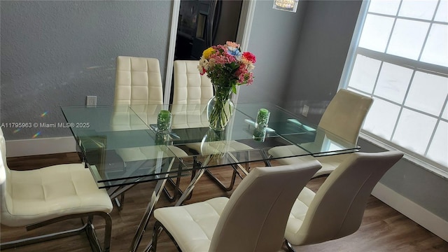 7310 NW 17th Ct, Pembroke Pines, FL 33024 - dining space featuring a textured wall, wood finished floors, and baseboards