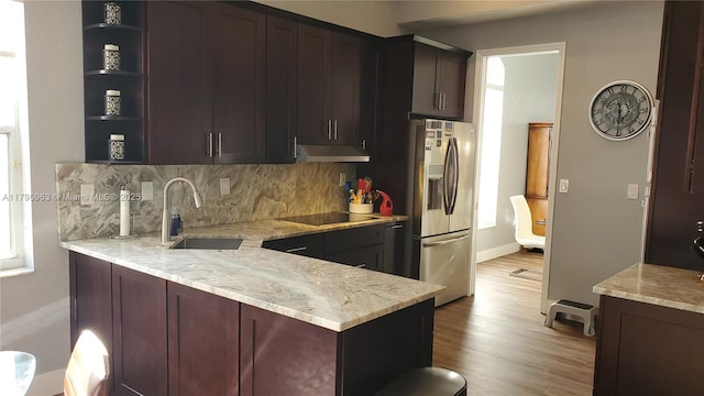 7310 NW 17th Ct, Pembroke Pines, FL 33024 - kitchen featuring stainless steel refrigerator with ice dispenser, a sink, open shelves, black electric stovetop, and backsplash