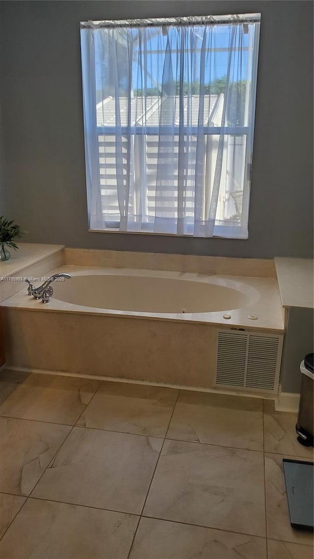 7310 NW 17th Ct, Pembroke Pines, FL 33024 - bathroom featuring healthy amount of natural light, a bath, and marble finish floors