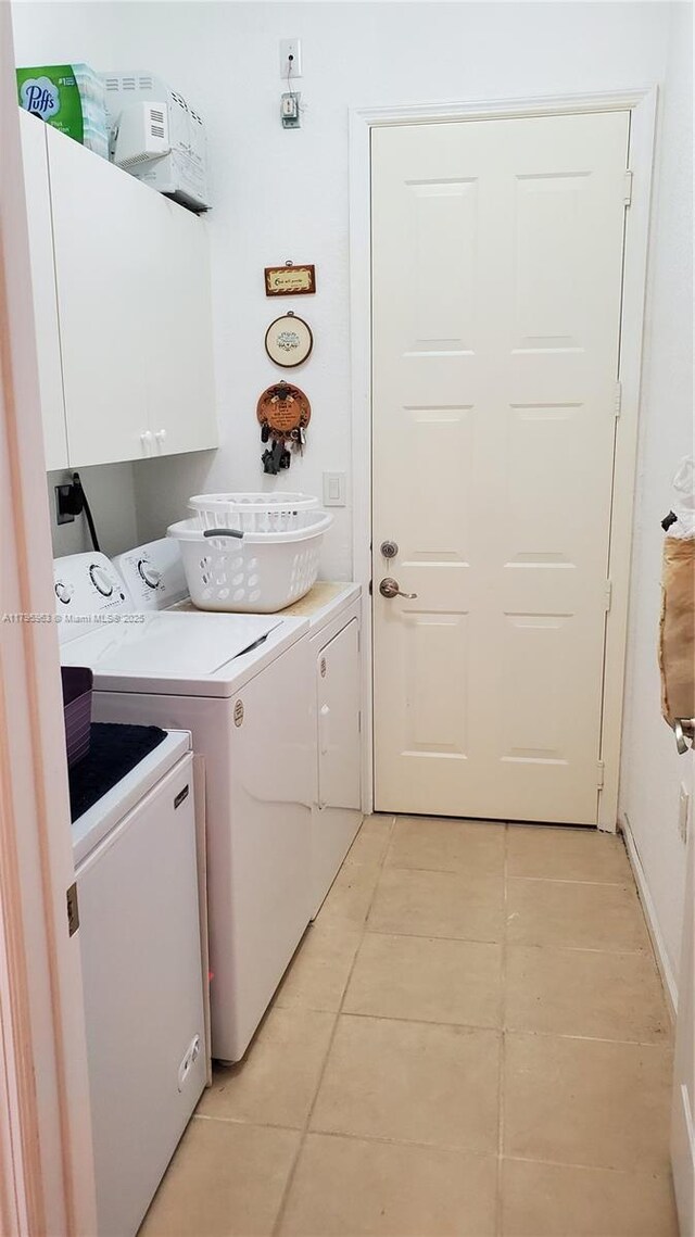 7310 NW 17th Ct, Pembroke Pines, FL 33024 - laundry area with cabinet space, washer and dryer, and light tile patterned floors