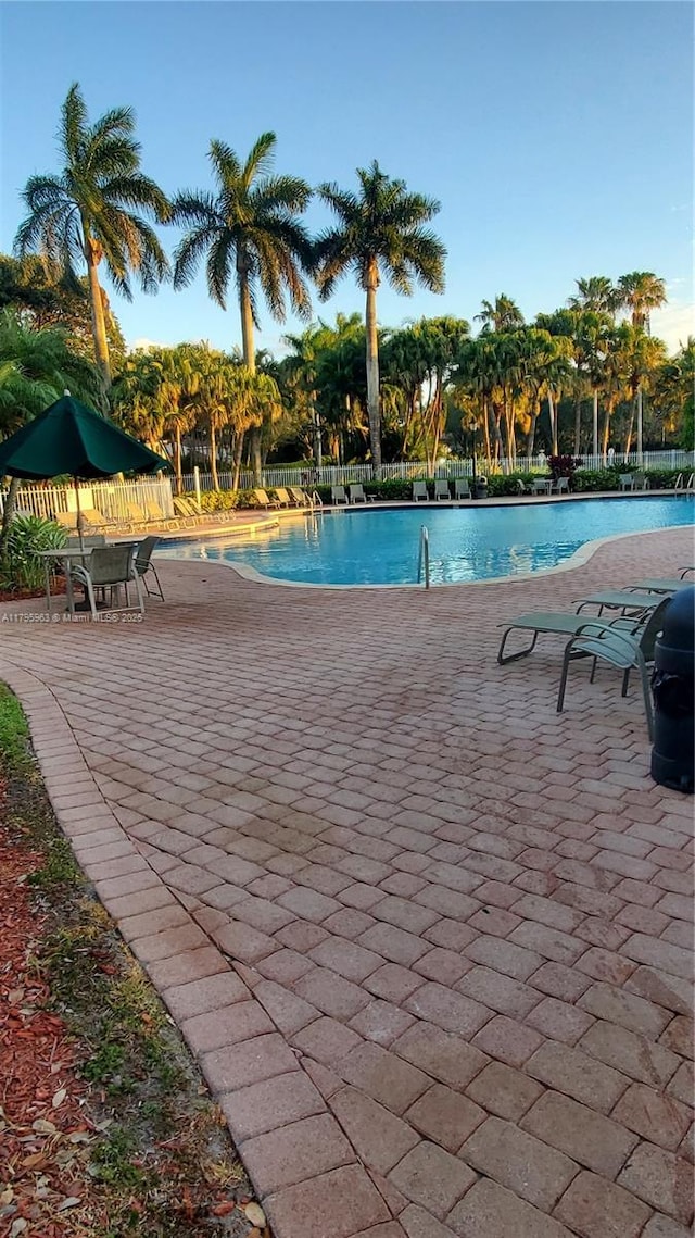 7310 NW 17th Ct, Pembroke Pines, FL 33024 - community pool with a patio and fence