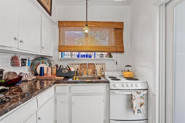 kitchen featuring dark countertops, electric stove, white cabinetry, tasteful backsplash, and a sink