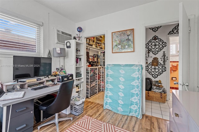 office with a wall unit AC and wood finished floors