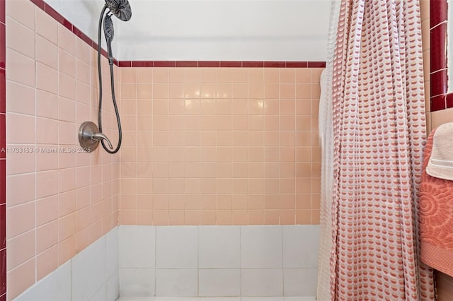 bathroom with a tile shower