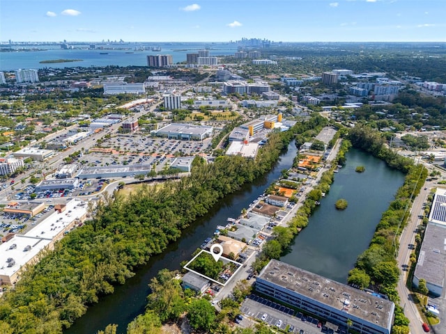 birds eye view of property with a view of city and a water view