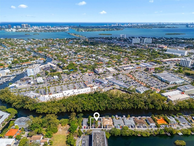 birds eye view of property with a view of city and a water view