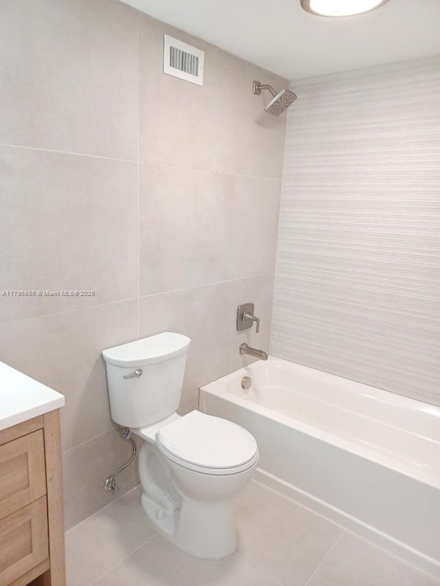 full bath with visible vents, tile patterned floors, toilet, and tile walls