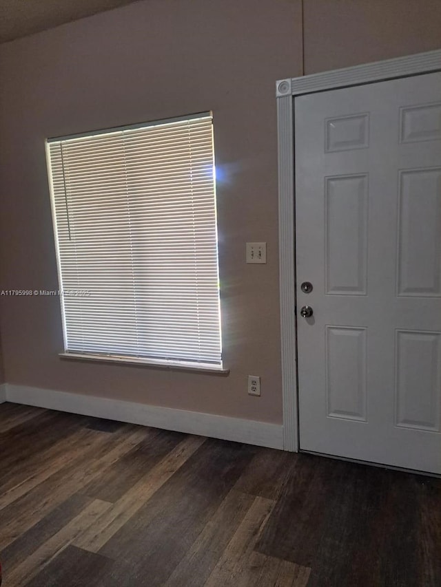 foyer with baseboards and dark wood finished floors