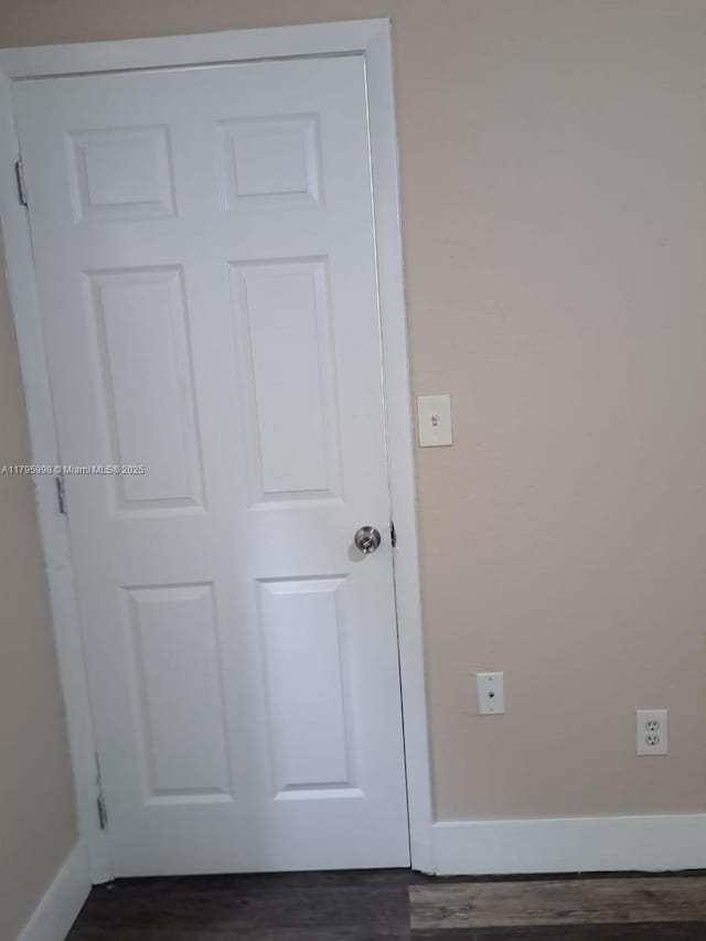interior details with baseboards and wood finished floors